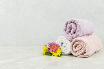 Obraz na płótnie Canvas towels beside flowers on marble floor