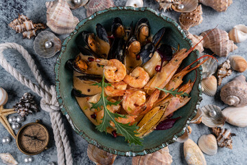 cooked phalanx of crab in a blue plate on an autumn background with hay and a glass of white wine