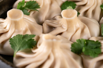 National Georgian cuisine. Khinkali with meat. Khinkali on a wooden board close-up.