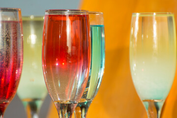 Cocktails in glass stemware on the bar counter.