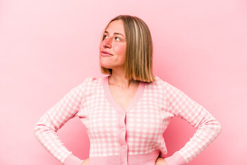 Young caucasian woman isolated on pink background dreaming of achieving goals and purposes