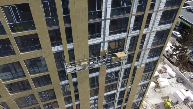 Building external wall thermal insulation with mineral wool. Exterior passive house wall heat insulation with mineral wool. Insulation the facade of commercial building. Energy efficiency