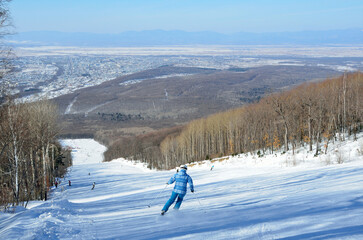 Man snowboarding on ski slope in the town of Arsenyev, Primorsky Krai, Far east, Russia