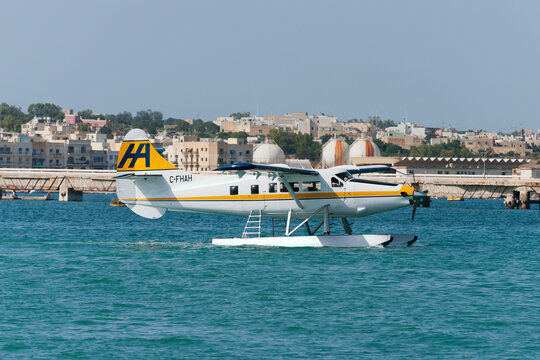 Birzebbuga, Malta June 28, 2007: Harbour Air Malta De Havilland Canada DHC-3T Vazar Turbine Otter has just been fitted with floats and lowered by crane into the sea to start its operations.