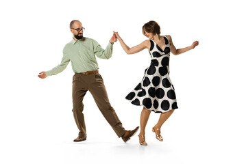 Naklejka premium Dynamic portrait of couple of dancers in vintage retro style outfits dancing lindy hop dance isolated on white background. Concept of art, action, motion