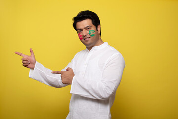 Young man celebrating holi 