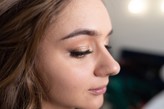 Girl's face with applied makeup close-up
