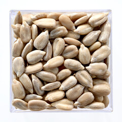 sunflower seeds lie in a square container. Use as salad spice. Vegetarianism, fiber, proper nutrition. Close-up, copy space, flat lay, macro, texture, top view, background
