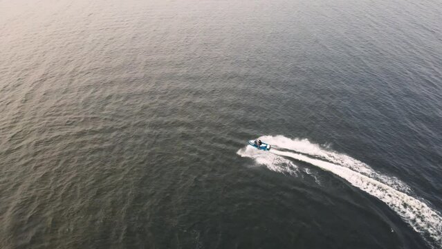 Guys riding jet skis on blue water in Sweden.