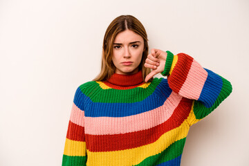 Young caucasian woman isolated on white background showing a dislike gesture, thumbs down....