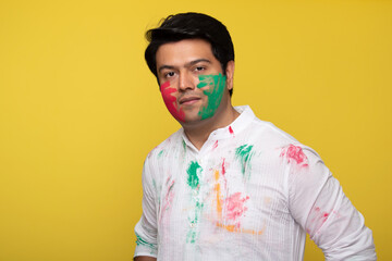 Young man celebrating holi 