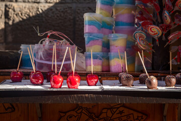 Candy apple, toffee apples, caramelized apples on a mobile stall in a medieval market