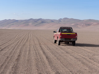 Fototapeta na wymiar Driving through open unmarked desert roads in the Atacama desert, Chile, near the border with Bolivia and Argentina