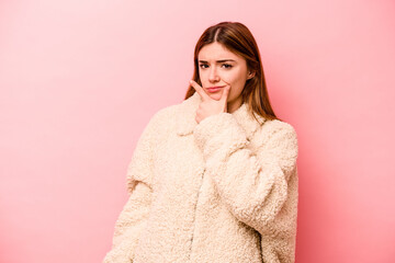 Young caucasian woman isolated on pink background contemplating, planning a strategy, thinking about the way of a business.