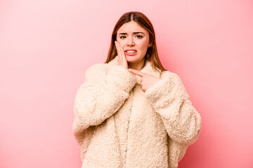 Young caucasian woman isolated on pink background having a strong teeth pain, molar ache.