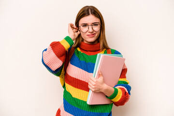 Young student caucasian woman isolated on white background covering ears with hands.