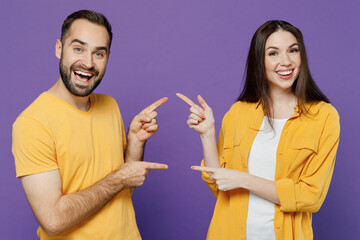 Young smiling happy cheerful fun cool couple two friends family man woman 20s together wear yellow...