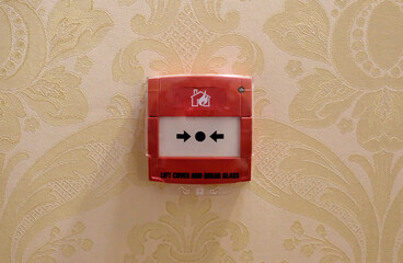 Fire alarm mounted on a wall in a hotel
