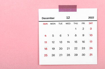 December 2022 calendar on pink background.