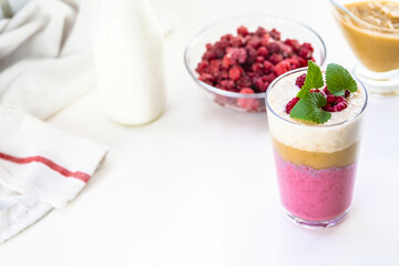 Delicious layered yogurt dessert with applesauce, raspberries and banana.