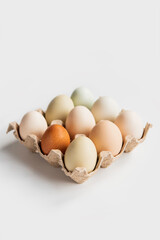 Set of 9 eggs in a cardboard tray.