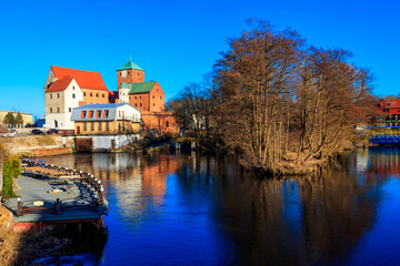Fototapeta premium Castle of the Pomeranian Dukes or Darlowo castle on a bank of the Wieprza river in Darlowo, Poland