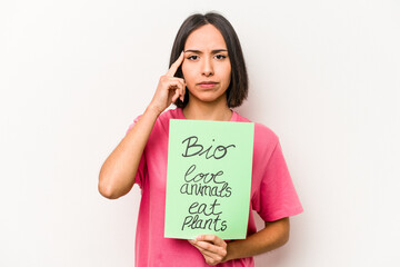 Young hispanic woman holding bio placard isolated on white background pointing temple with finger, thinking, focused on a task.