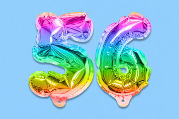 Rainbow foil balloon number, digit fifty six on a blue background. Birthday greeting card with inscription 56. Top view. Numerical digit. Celebration event, template.