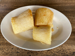Fried cassava slices on a white plate. Focus selected
