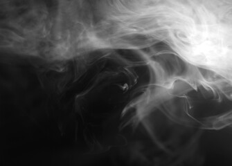 Abstract smoke texture over black. Fog in the darkness.