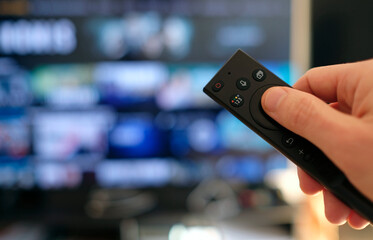 Remote control and screen - binge watching the favorite TV show
