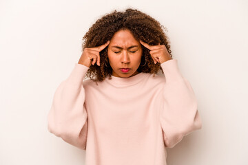 Young African American woman isolated on white background focused on a task, keeping forefingers pointing head.