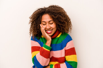 Young African American woman isolated on white background laughs happily and has fun keeping hands on stomach.