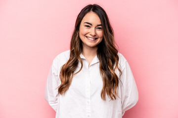 Young caucasian woman isolated on pink background happy, smiling and cheerful.