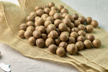 a macadamia nuts on burlap background backdrop