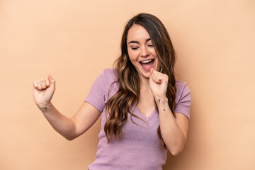 Young caucasian woman isolated on beige background dancing and having fun.
