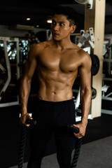 Fototapeta na wymiar Fitness man exercise training warm up body and posing in gym,Healthy lifestyle.