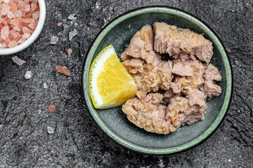 Canned tuna fish in bowl. Low calories healthy eating snack of preserved tuna fish. Tasty seafood. place for text, top view