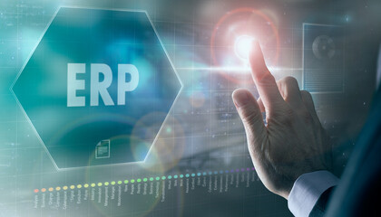 A businessman controlling a futuristic display with a ERP business concept on it.