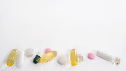 pills and capsules on white background, with free  space for text