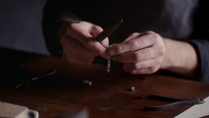 Close-up of men's hands making jewelry. Creating beautiful accessories