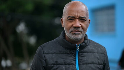 Naklejka premium A senior black man portrait face with serious expression looking at camera