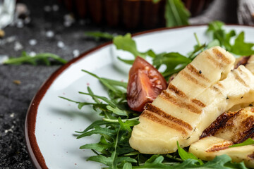 vegeterian salad with fried halloumi and tomatoes, closeup, keto ketogenic diet. Delicious breakfast or snack, Clean eating, dieting, vegan food concept. top view