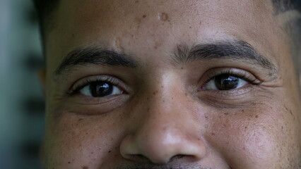 A hispanic black man eyes close-up face smiling looking at camera