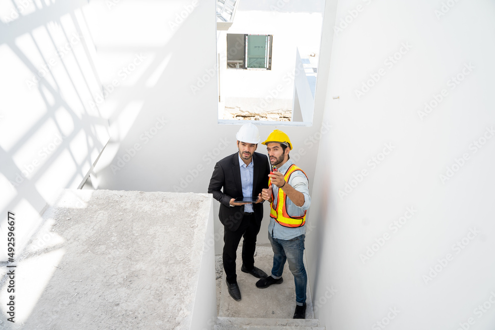 Poster Engineer with business manager are talking in construction site,Project owner with blueprint working to new residential home building work site.