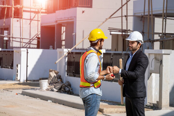 Businessman and architect shake hand success at construction...