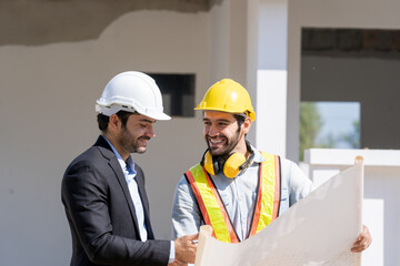 Engineer with business manager are talking in construction site,Project owner with blueprint working to new residential home building work site.