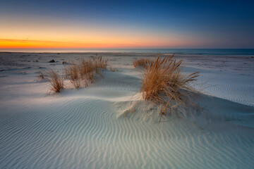 Beautiful scenery of the Baltic Sea beach at sunset, Slowinski National Park, Leba. Poland
