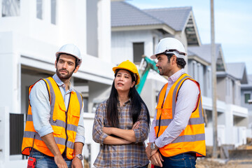Engineer and architect discussing building plan at construction site,Group of builders having...