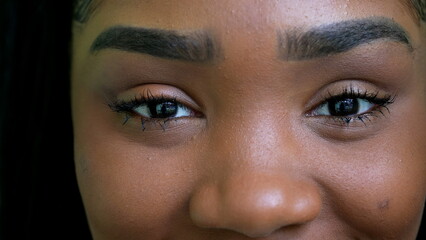 A black teen girl closing eyes in meditation person opening eye macro close-up